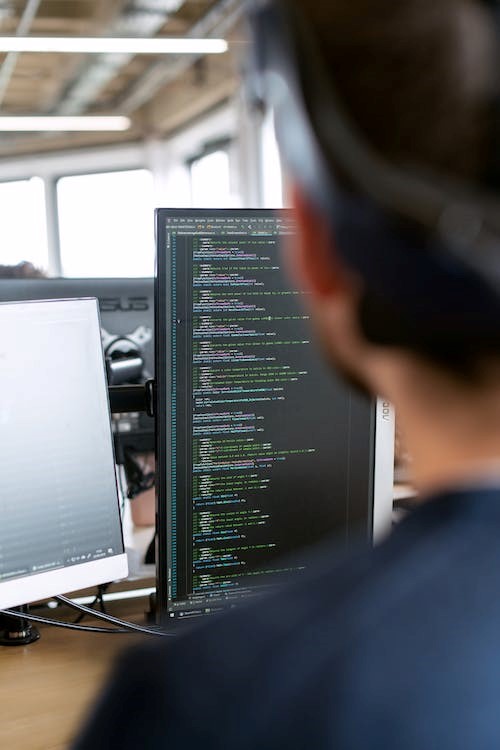 QA tester reviewing code on vertical screen