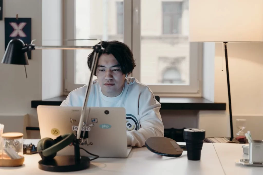 Asian software developer working on laptop