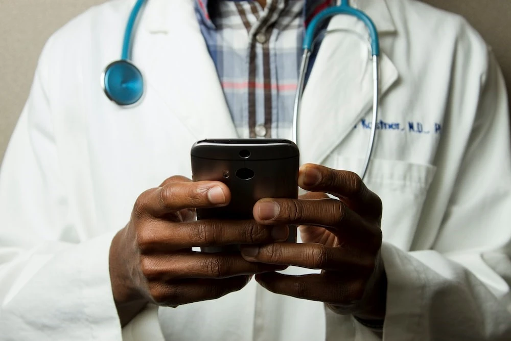 Doctor consulting with peers through phone